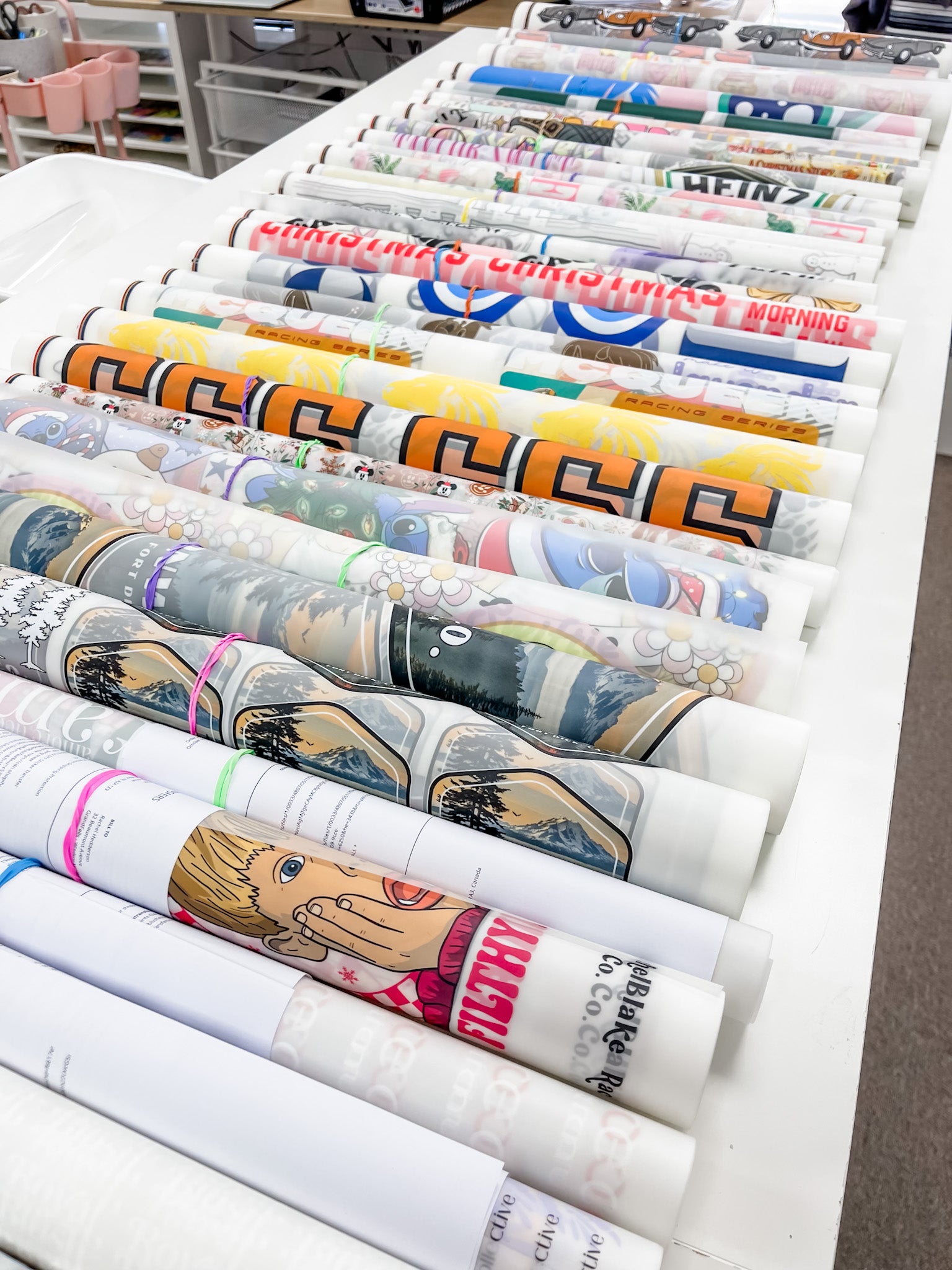 Multiple custom DTF gang sheets printed with vibrant full-colour designs ready for apparel decoration.