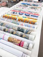 Multiple custom DTF gang sheets printed with vibrant full-colour designs ready for apparel decoration.