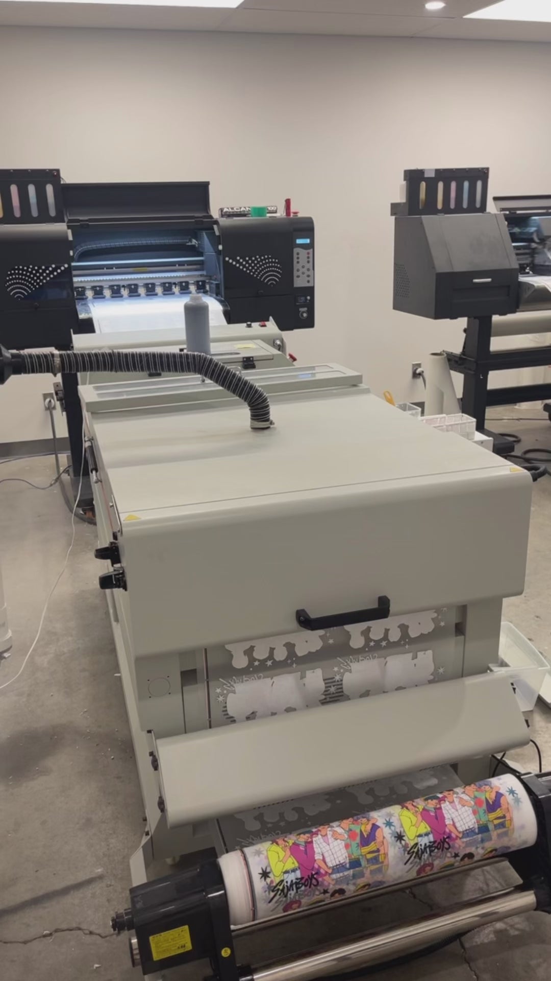 Printing custom DTF gang sheets using professional Direct to Film printing equipment.